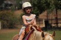 Charli rides her first horse