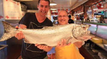 Clint holding a huge salmon in Granville Island, Vancouver