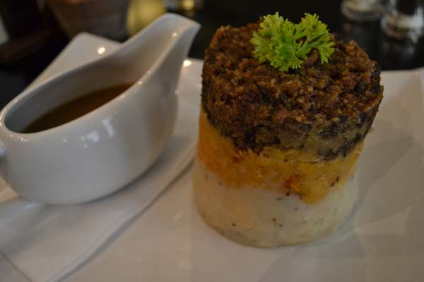 Mashed turnip, potato and haggis with whiskey sauce in Scotland