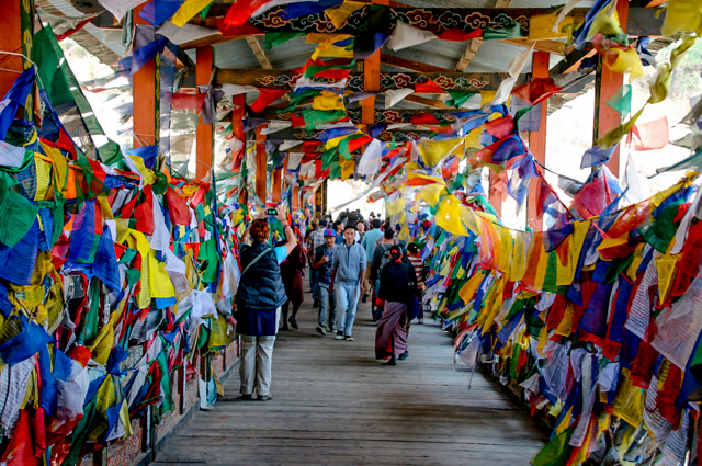 Prayer flags on the bridge over River Thimphu trekking Bhutan